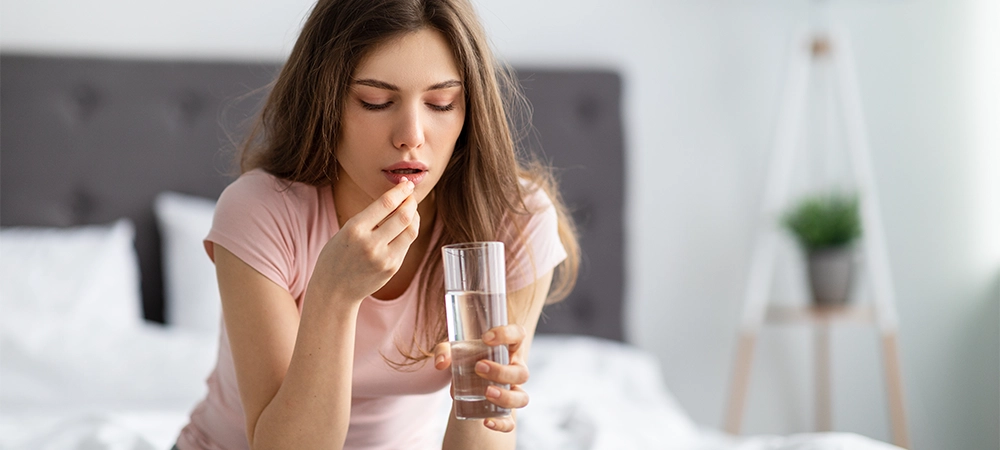 girl taking pills