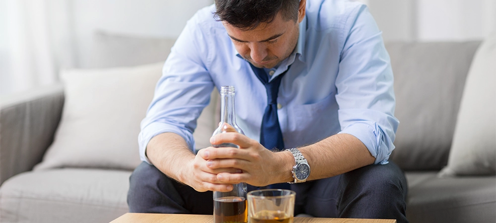 man consuming large amounts alcohol in one sitting