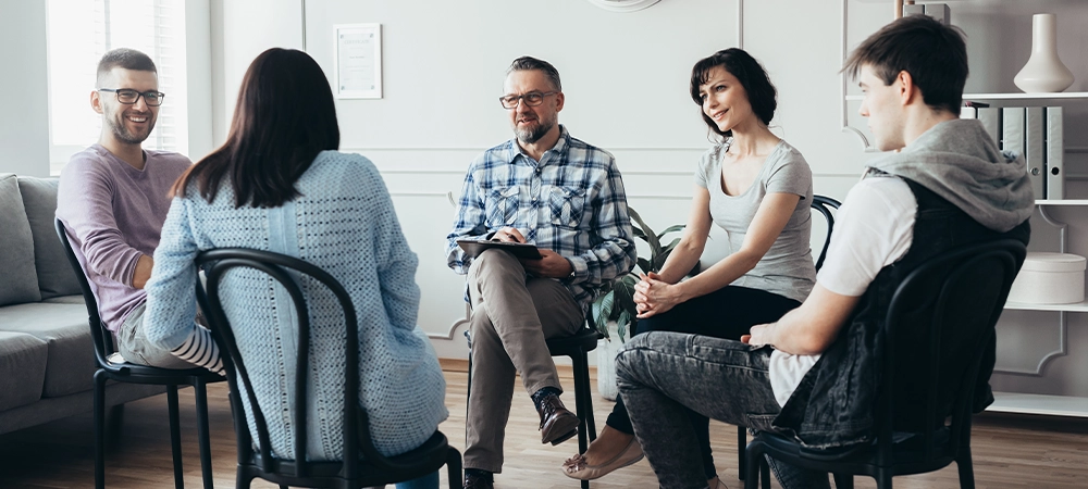 addiction rehab therapists meeting with clients