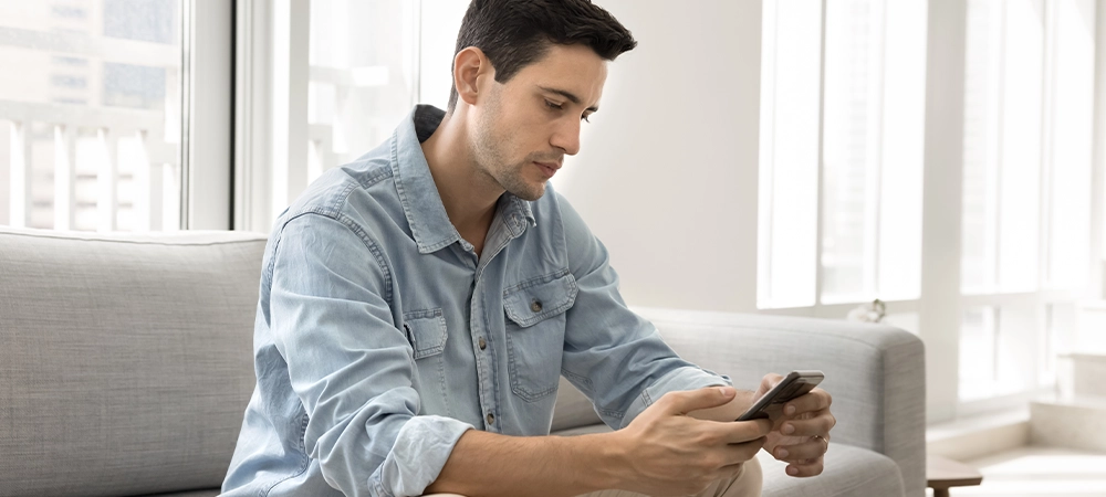 man texting on mobile for support