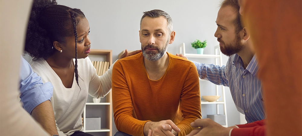 multiracial people communicate and support each other in group therapy session